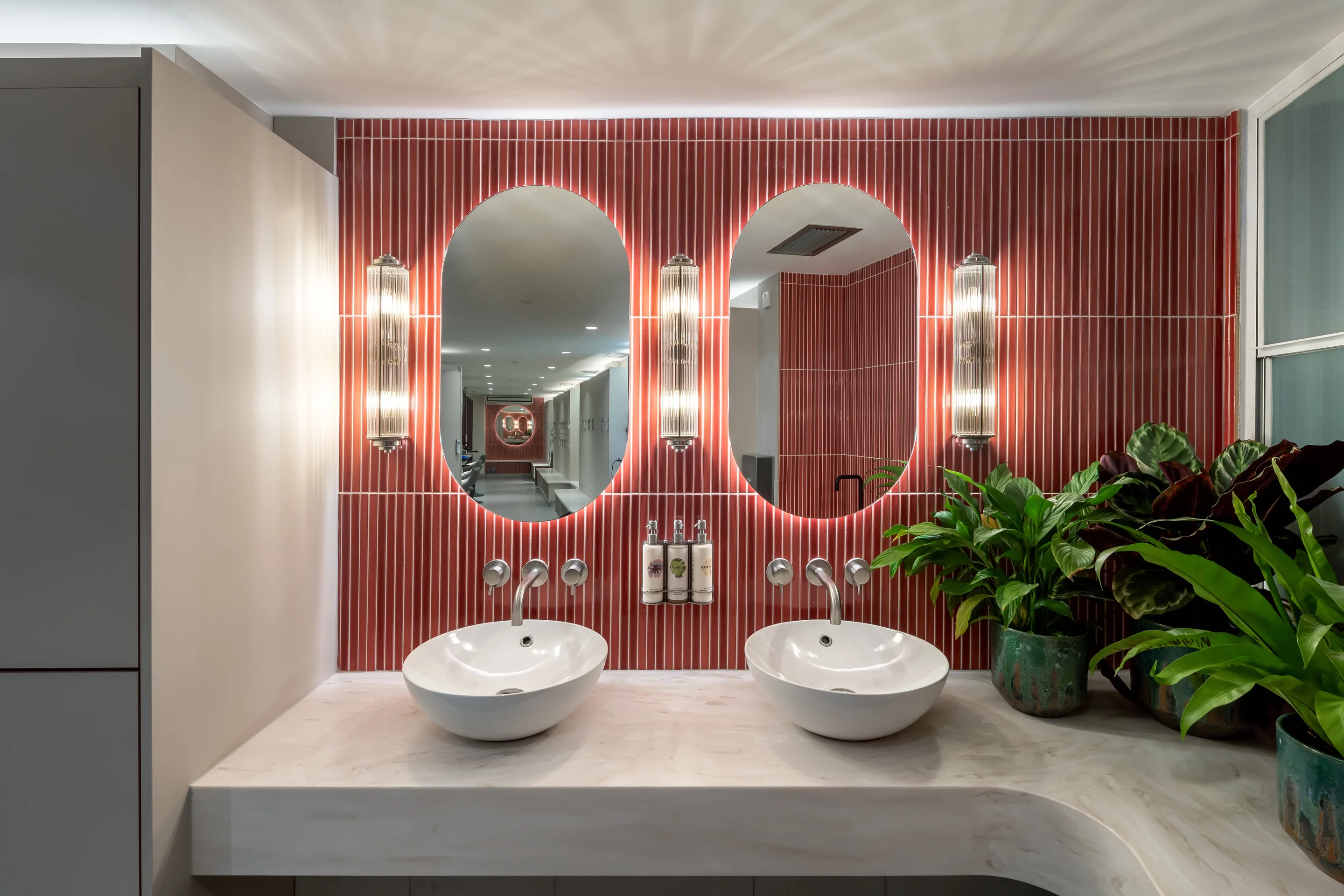 Changing room vanity with oval mirrors at Body Works West